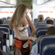 ‘Hooters Girl’ Hillary Vinson, front, attends to passengers aboard the inaugural flight of Hooters Air March 6, 2003 from Atlanta, Georgia to Myrtle Beach, South Carolina.